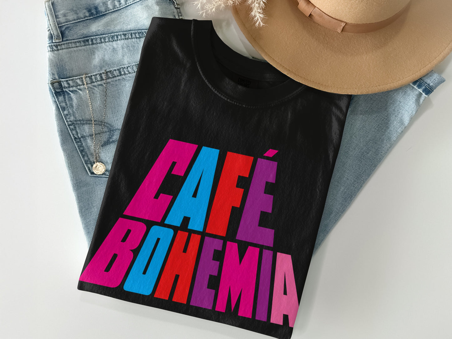 Black t-shirt with "CAFÉ BOHEMIA" in large, colorful block letters.