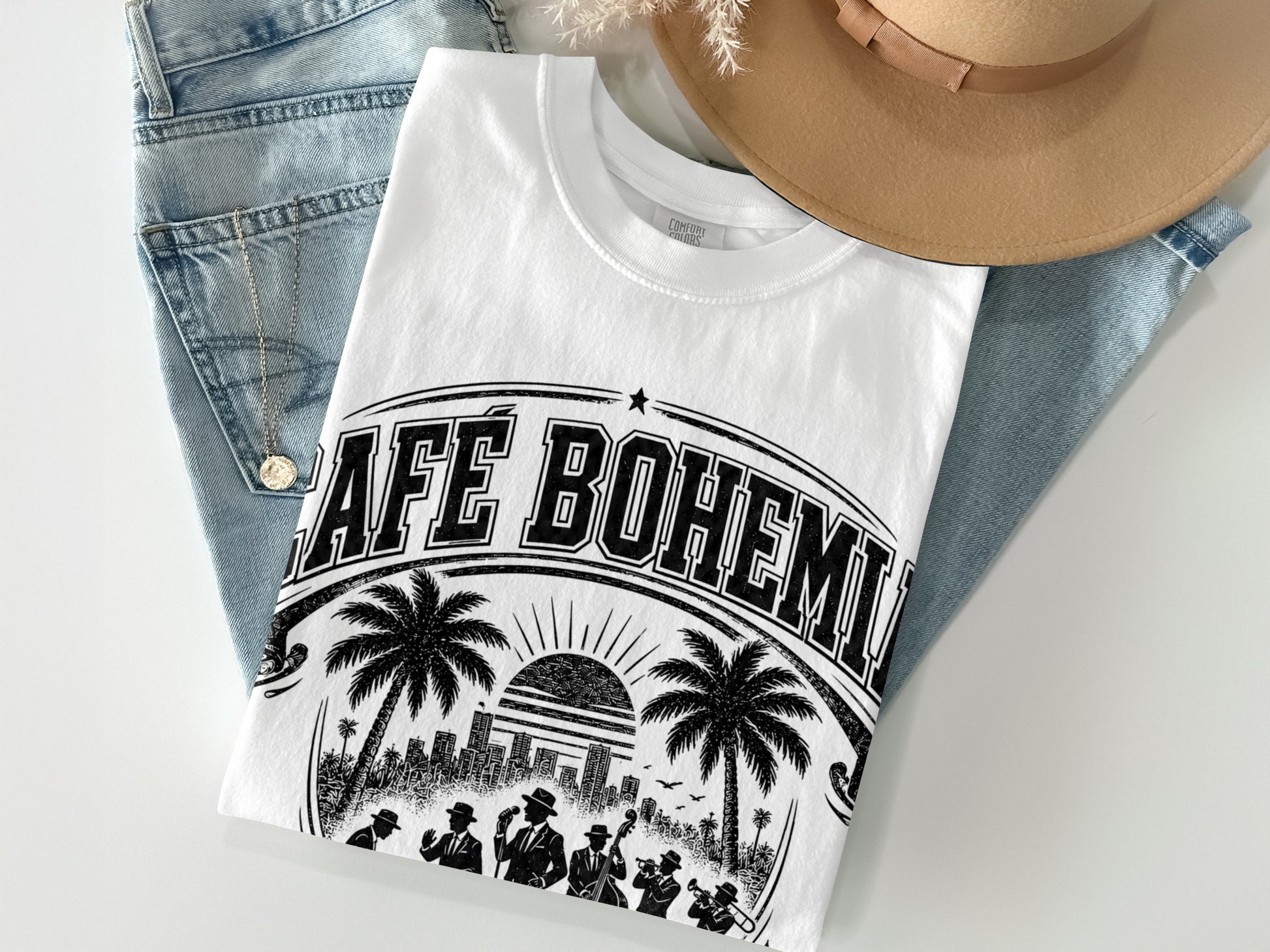 White t-shirt with "Cafe Bohemia" text, palm trees, and cityscape graphic.