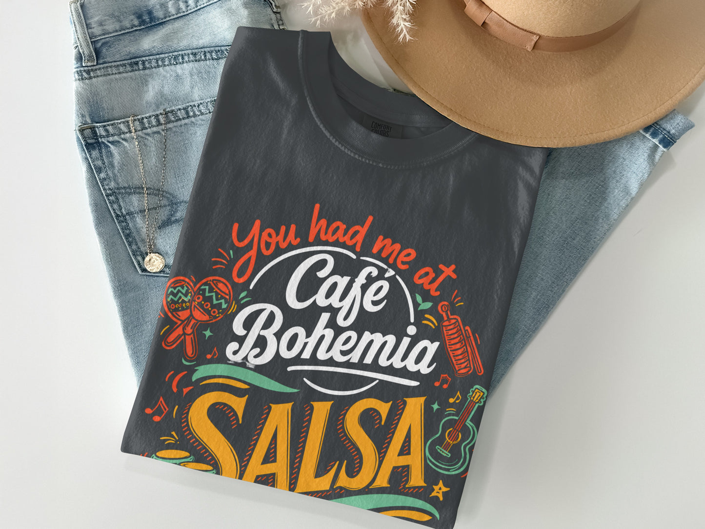 Dark t-shirt with "You had me at Cafe Bohemia SALSA" and colorful graphics.
