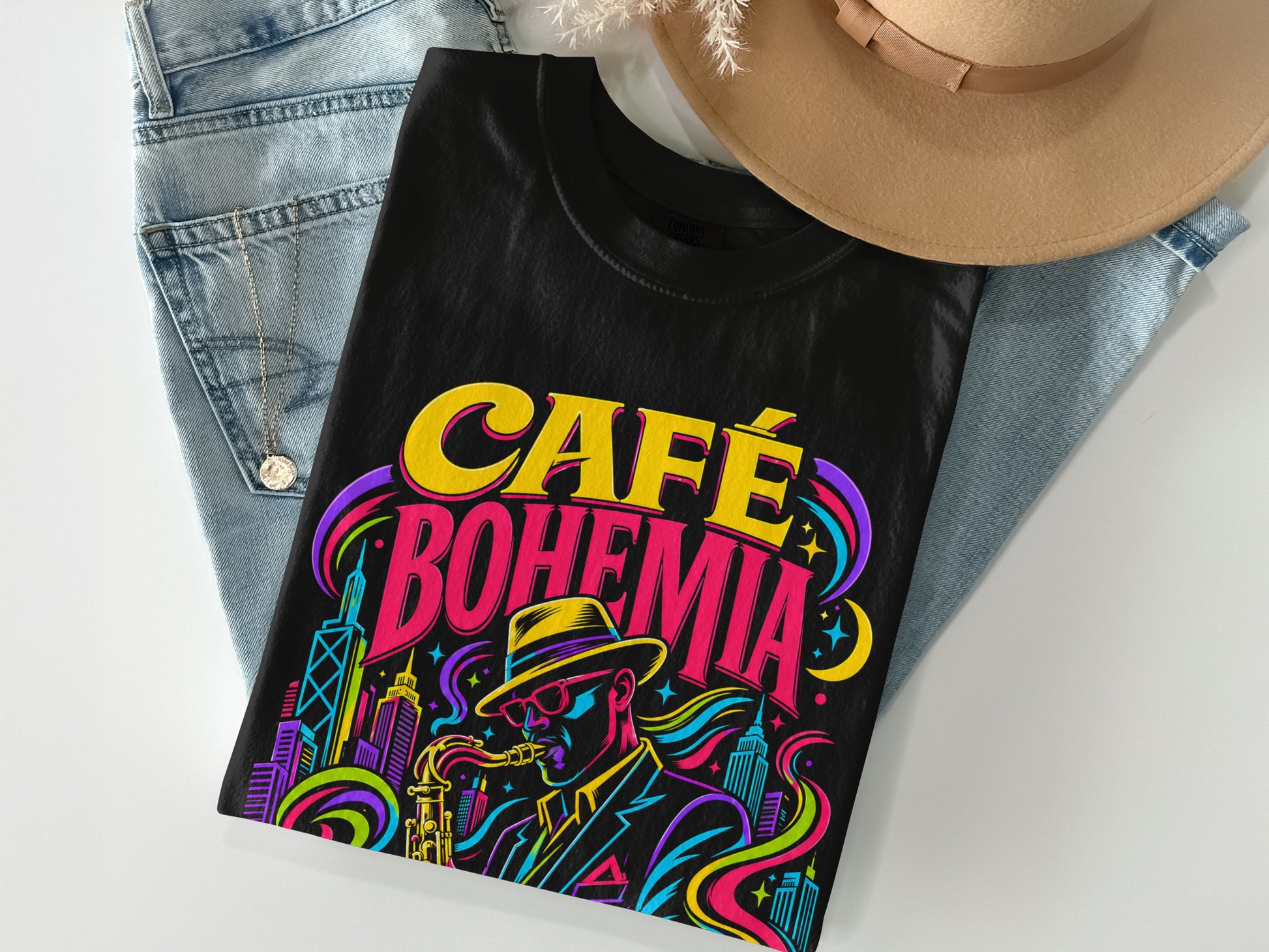 Black t-shirt with colorful "Café Bohemia" text and a saxophone player in a city.